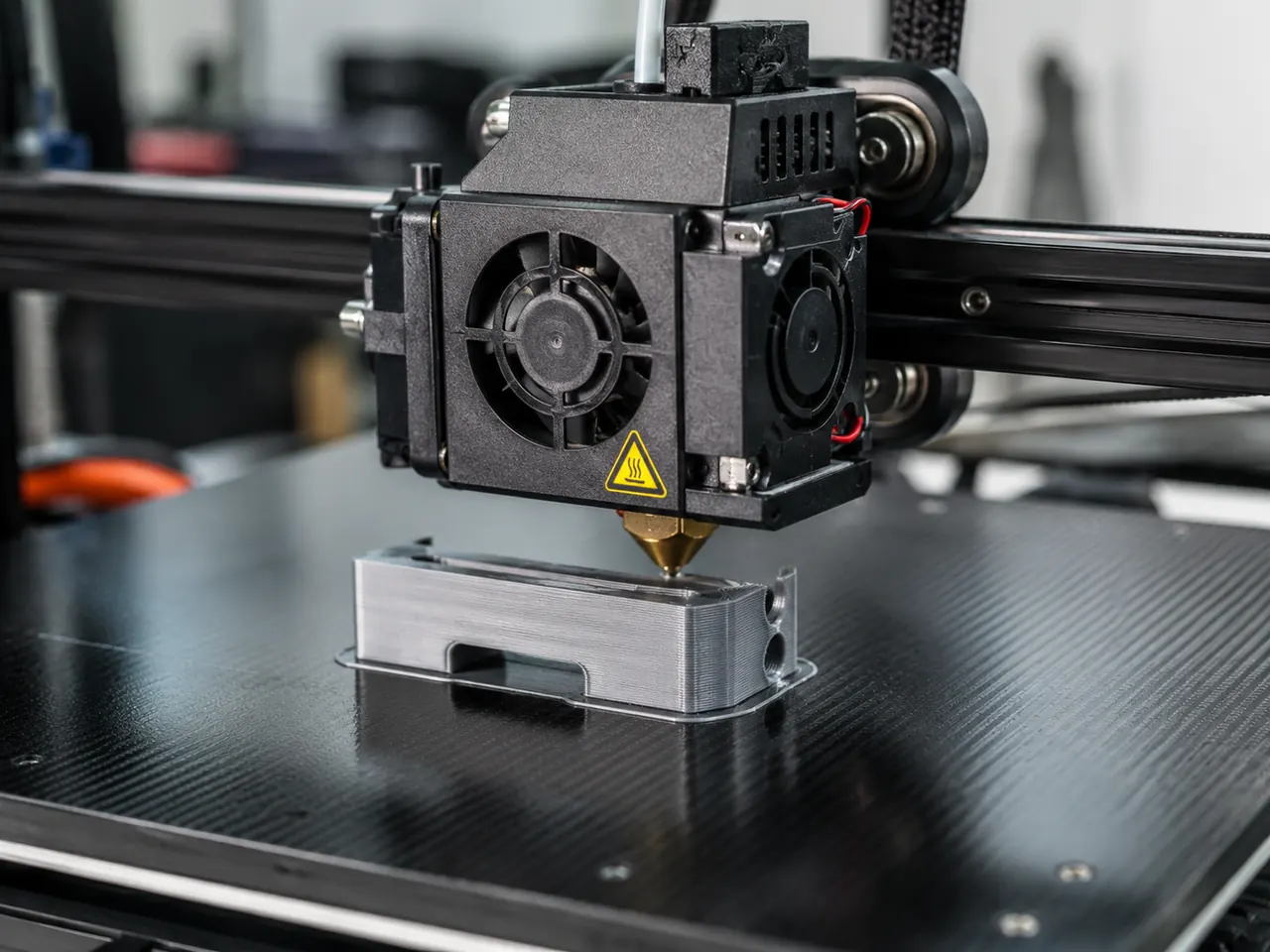 3D printer building a polymer part